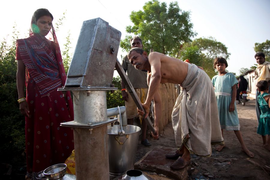People in the Amalayub Nagar of Bhopal collect water from a pump. They live close to the abandoned Union Carbide factory which is causing a second crisis in the city by poisoning the water supply with heavy metals.
