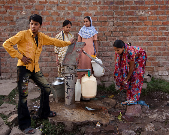 Women collecting water from a standpipe in the street in Bhopal. Photo by David Graham